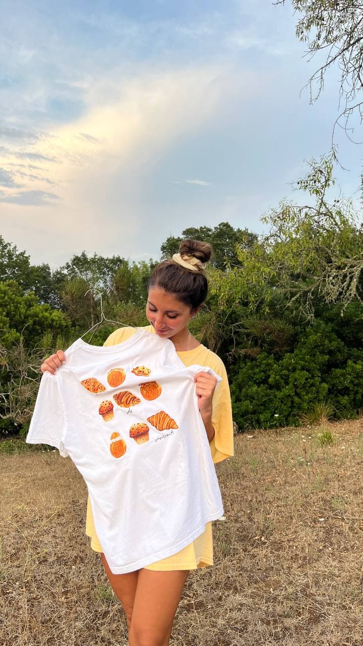 Michela Sharon con in mano una t-shirt Paneelatte con stampa di dolci da forno